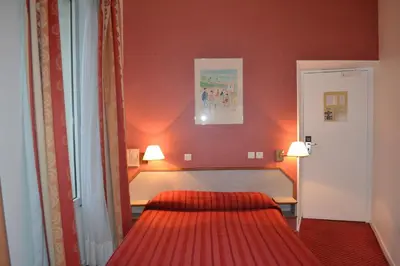 Un ou plusieurs lits dans un hébergement de l'établissement Hotel William's Opera