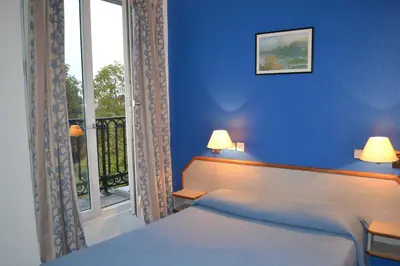 Un ou plusieurs lits dans un hébergement de l'établissement Hotel William's Opera