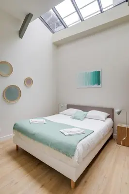 Un ou plusieurs lits dans un hébergement de l'établissement Lofts Philippe-Auguste