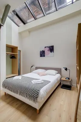 Un ou plusieurs lits dans un hébergement de l'établissement Lofts Philippe-Auguste