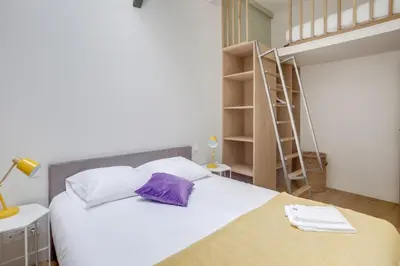 Un ou plusieurs lits dans un hébergement de l'établissement Lofts Philippe-Auguste