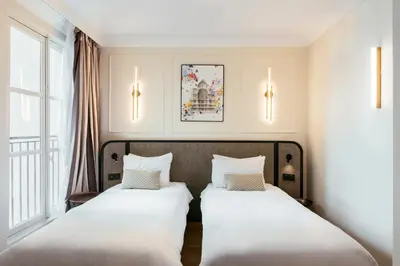 Un ou plusieurs lits dans un hébergement de l'établissement Aparthotel Adagio Paris Opéra