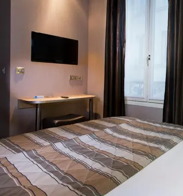 Un ou plusieurs lits dans un hébergement de l'établissement Hôtel des Pavillons