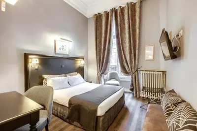 Un ou plusieurs lits dans un hébergement de l'établissement Hotel Opera Maintenon