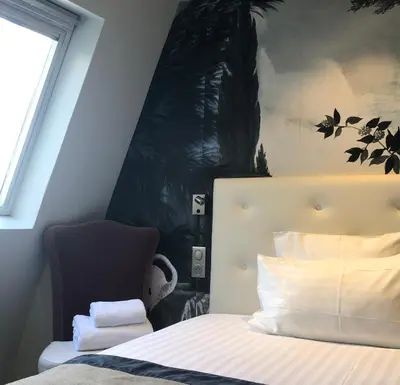 Un ou plusieurs lits dans un hébergement de l'établissement Hotel Taylor