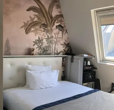 Un ou plusieurs lits dans un hébergement de l'établissement Hotel Taylor