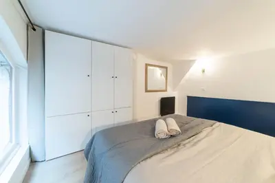 Un ou plusieurs lits dans un hébergement de l'établissement Architect's Duplex - Haut Marais