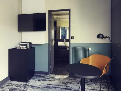 Télévision ou salle de divertissement dans l'établissement Hôtel Relais de Lyon By Malone