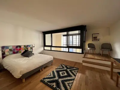 Un ou plusieurs lits dans un hébergement de l'établissement Hôtel Villa Blomet