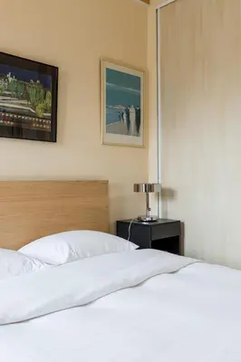 Un ou plusieurs lits dans un hébergement de l'établissement Veeve - Quai aux Fleurs Apartment