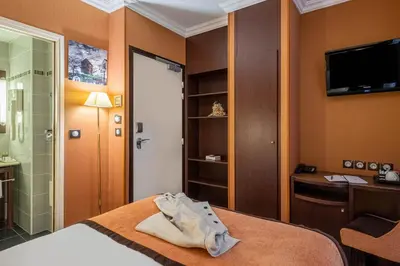Un ou plusieurs lits dans un hébergement de l'établissement Hôtel 85 Saint Honore