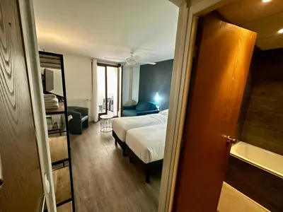 Un ou plusieurs lits dans un hébergement de l'établissement Hôtel du Maine