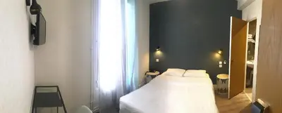 Un ou plusieurs lits dans un hébergement de l'établissement Hôtel du Maine