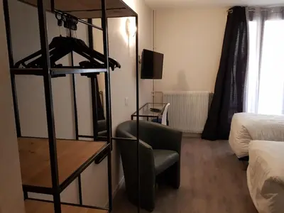 Un ou plusieurs lits dans un hébergement de l'établissement Hôtel du Maine