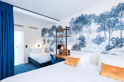 Un ou plusieurs lits dans un hébergement de l'établissement Hotel Bleu de Grenelle - Tour Eiffel