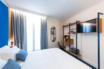 Un ou plusieurs lits dans un hébergement de l'établissement Hotel Bleu de Grenelle - Tour Eiffel