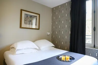 Un ou plusieurs lits dans un hébergement de l'établissement Hôtel Helzear Champs-Elysées by Esteem