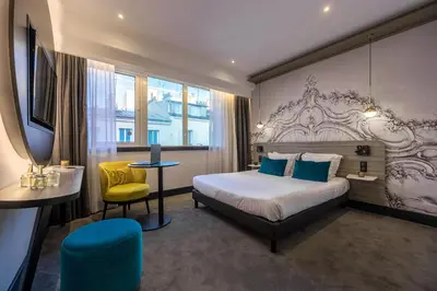 Un ou plusieurs lits dans un hébergement de l'établissement Nemea Appart Hotel Paris Levallois