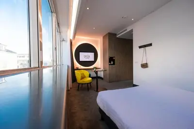 Un ou plusieurs lits dans un hébergement de l'établissement Nemea Appart Hotel Paris Levallois