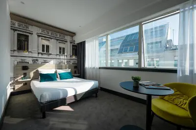 Un ou plusieurs lits dans un hébergement de l'établissement Nemea Appart Hotel Paris Levallois