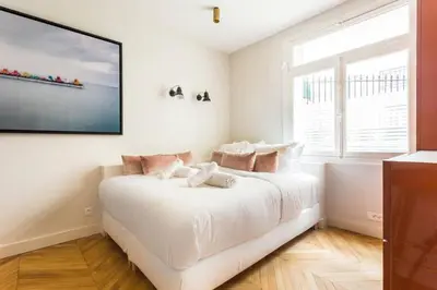 Un ou plusieurs lits dans un hébergement de l'établissement Appartement Studio Trocadéro