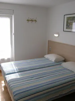 Un ou plusieurs lits dans un hébergement de l'établissement Hotel Darcet