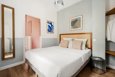 Un ou plusieurs lits dans un hébergement de l'établissement Edgar Suites Grands Boulevards - Hauteville