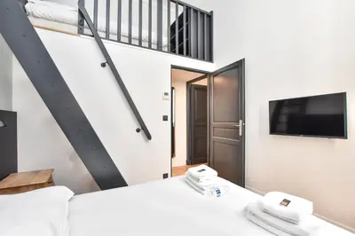 Un ou plusieurs lits dans un hébergement de l'établissement Cosy apartment - 2BR-7P - Arc de Triomphe