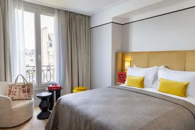 Un ou plusieurs lits dans un hébergement de l'établissement Hotel Le 37 Bis