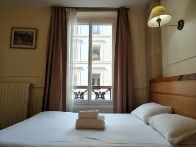 Un ou plusieurs lits dans un hébergement de l'établissement Hotel Havane Opera