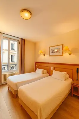 Un ou plusieurs lits dans un hébergement de l'établissement Hotel Havane Opera