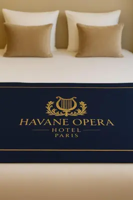 Un ou plusieurs lits dans un hébergement de l'établissement Hotel Havane Opera
