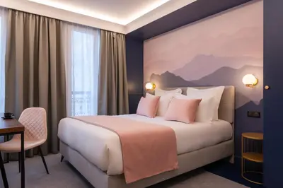 Un ou plusieurs lits dans un hébergement de l'établissement Hôtel Le Milie Rose