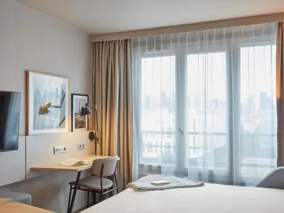Un ou plusieurs lits dans un hébergement de l'établissement Aparthotel Adagio Paris Suresnes Longchamp