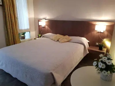 Un ou plusieurs lits dans un hébergement de l'établissement HOTEL ALISON