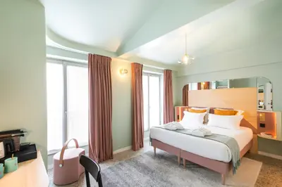 Un ou plusieurs lits dans un hébergement de l'établissement Hôtel Amoi Paris
