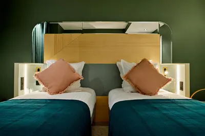 Un ou plusieurs lits dans un hébergement de l'établissement Hôtel Amoi Paris