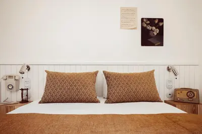 Un ou plusieurs lits dans un hébergement de l'établissement Hôtel Monsieur Aristide