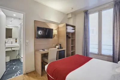 Un ou plusieurs lits dans un hébergement de l'établissement Hôtel LUX PICPUS