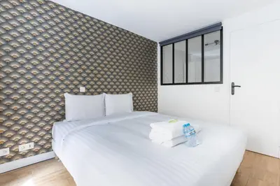 Un ou plusieurs lits dans un hébergement de l'établissement Appartement Duplex de Charme proche de l'opéra Garnier