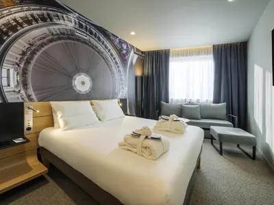 Un ou plusieurs lits dans un hébergement de l'établissement Novotel Paris 20 Belleville