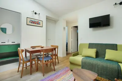 Télévision ou salle de divertissement dans l'établissement Résidence Le Marais by Studio prestige