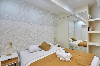 Un ou plusieurs lits dans un hébergement de l'établissement Apartement Le Marais by Studio prestige