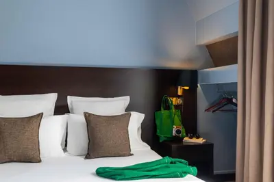 Un ou plusieurs lits dans un hébergement de l'établissement Hôtel Sophie Germain