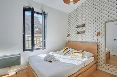 Un ou plusieurs lits dans un hébergement de l'établissement Residence Boulogne Centre le passage by Studio prestige