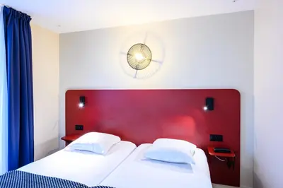 Un ou plusieurs lits dans un hébergement de l'établissement Hôtel D'Alsace