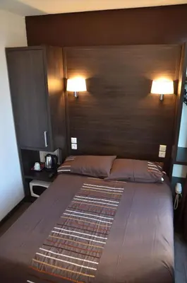 Un ou plusieurs lits dans un hébergement de l'établissement Hôtel du Parc