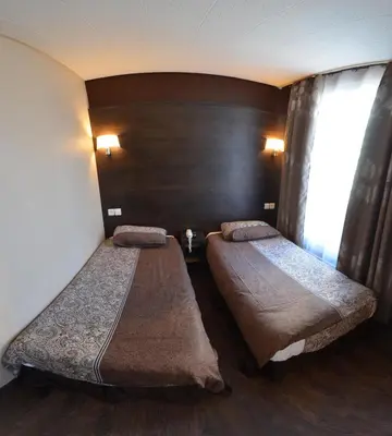 Un ou plusieurs lits dans un hébergement de l'établissement Hôtel du Parc