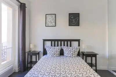 Un ou plusieurs lits dans un hébergement de l'établissement Champs de Mars Appartement