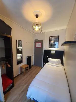 Un ou plusieurs lits dans un hébergement de l'établissement HOTEL SAVOY